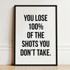 Black framed canvas print with white text that reads You lose 100% of the shots you don't take.