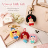 A collection of kawaii plush bag charms and keychains featuring cute stuffed animals on a light pink background.