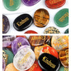 A collection of polished natural crystal ellipses in various colors including green, purple, orange, and red.