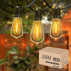 Three glass LED bulbs hanging outdoors against a blurred green background.