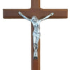 Hand carved wooden cross wall decor featuring a silver-colored figure of Christ.