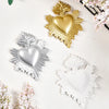 Gold and silver resin heart wall decorations with feather accents on a white background