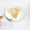 A white pearl-tipped bamboo cocktail pick is shown next to a hand, demonstrating its 12cm length.