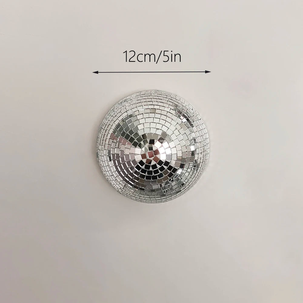 Silver disco ball decor with a 12cm diameter, mounted on a wall.