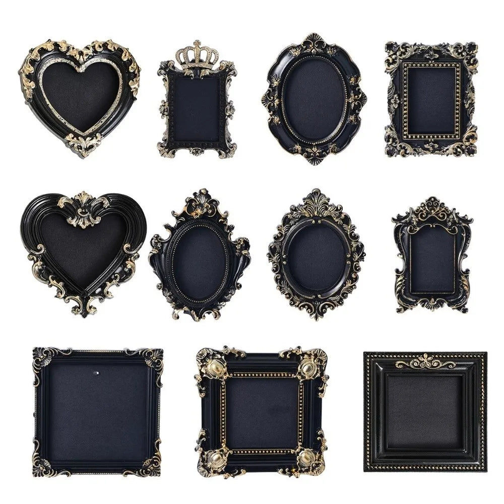 A collection of vintage baroque resin hanging photo frames in black and gold finishes.