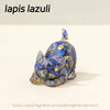 A small statue of a cat made from blue lapis lazuli crystal fragments bonded with resin.