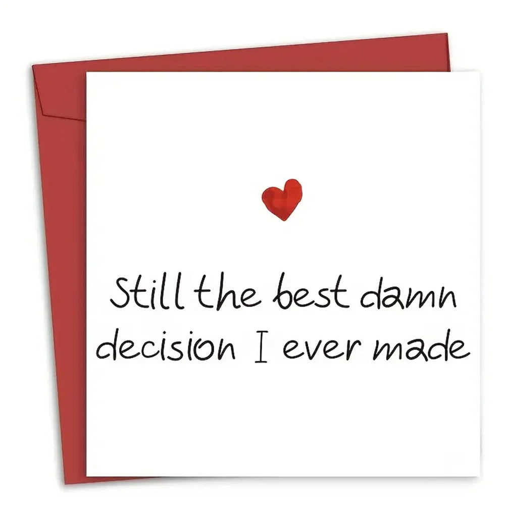 A red envelope with a white card featuring a small red heart and the text Still the best damn decision I ever made