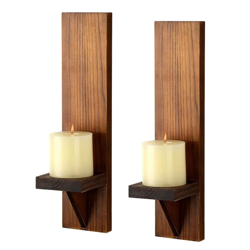 Two vertical wooden wall candle holders with cylindrical white candles.
