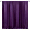 A floor-to-ceiling purple pleated drapery backdrop for events