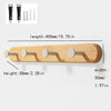 Solid beech wood wall hook rack with four wooden hooks shown in a close-up view.