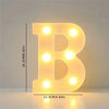 A glowing letter B made of LED lights, used for cozy room or party decor.