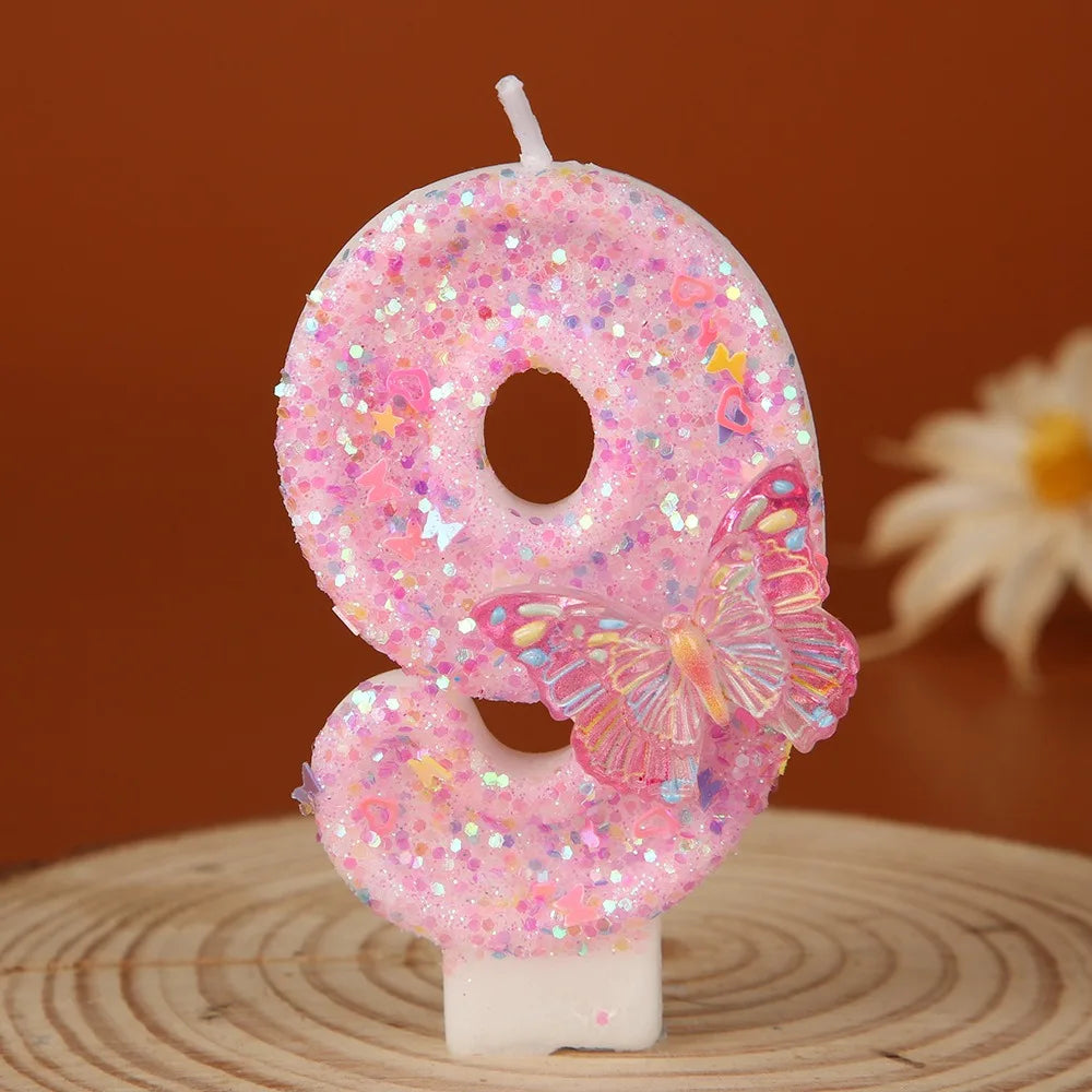 Pink glitter birthday candles shaped like the number 8 and a butterfly