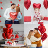 A collage of red heart foil balloons, including a couple kissing and a baby, set against a white background.