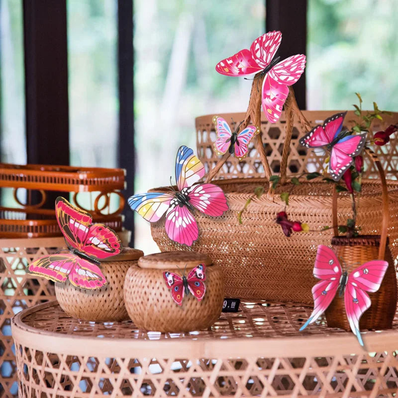 A decorative set of twelve pink and multicolored 3D butterfly wall stickers displayed in a woven basket.