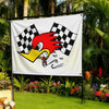A white flag featuring a red rooster head design with a black and white checkered pattern, displayed outdoors.