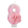 Pink glitter number eight cake candle with a pink bow for birthday or anniversary