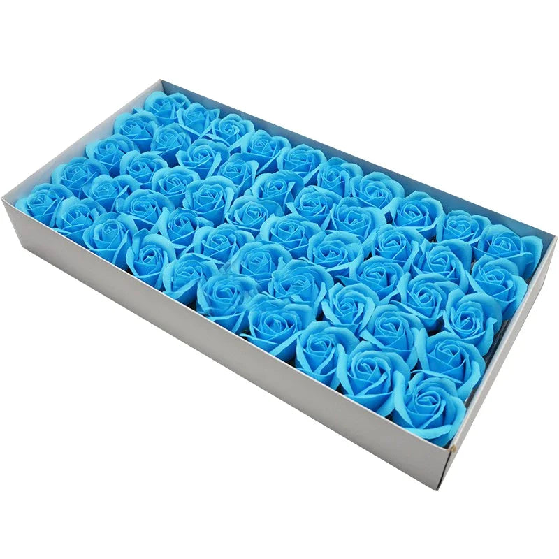 A rectangular box filled with numerous blue artificial rose heads for wedding and party decor.