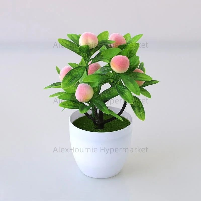 Artificial lemon tree bonsai with pink and green leaves planted in a white pot