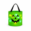 A bright green glowing pumpkin candy bucket with a black LED handle.