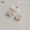 A single handmade soy wax flower tea light candle in a light pink color is shown packaged with a label and a small pink flowe