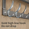 A close-up of a gold high-low hook over-the-door organizer rack designed to prevent items from dropping.