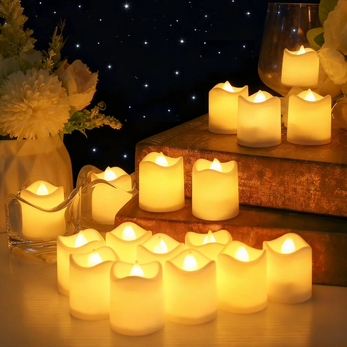 A collection of glowing white votive tea lights arranged on wooden surfaces and a glass holder.