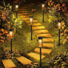 A pathway lined with retro solar lights leading through a lush, overgrown garden.
