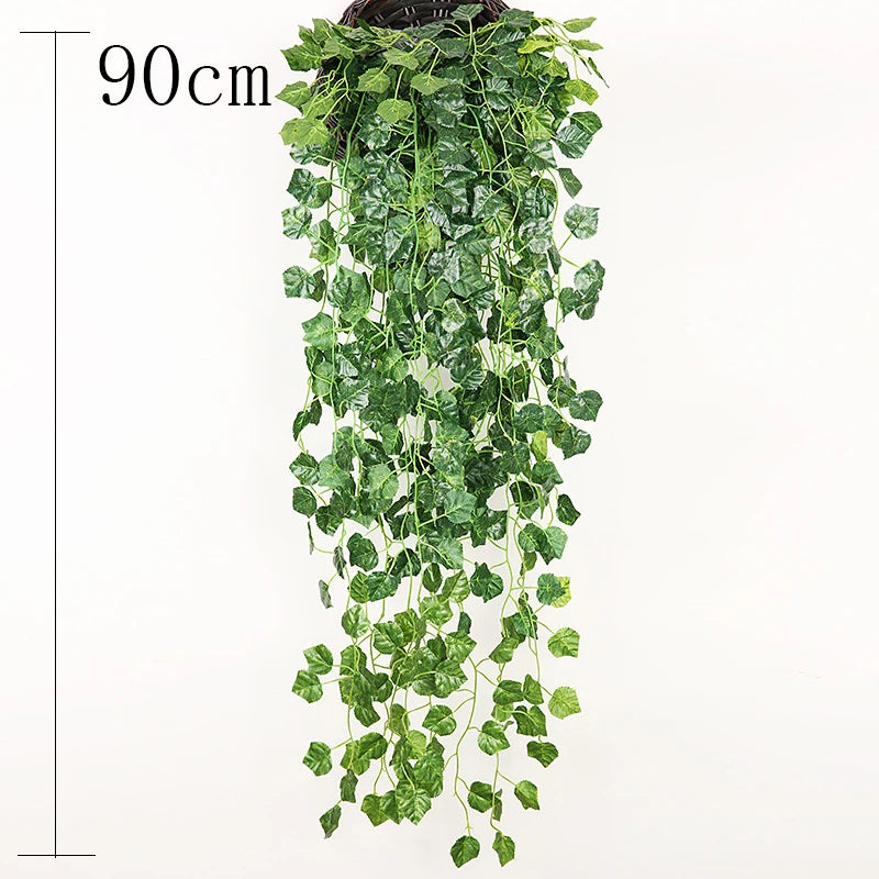 A long, vertical wall hanging made of artificial green plant vines.