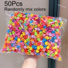 A plastic bag filled with 50 colorful flower and star hair claw clips for kids