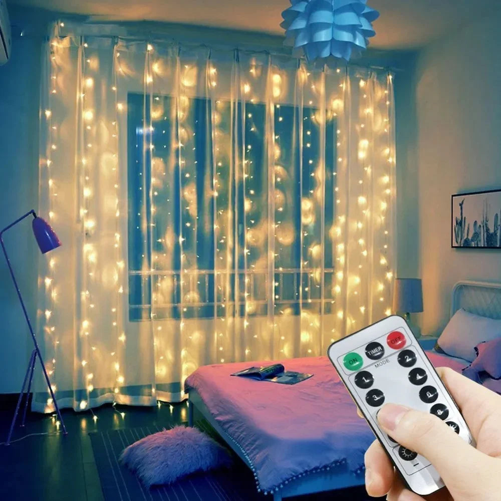 A hand holds a remote control for USB-powered LED curtain lights illuminating sheer curtains with warm glowing lights.