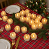 A festive holiday table setting featuring numerous glowing LED tea light candles on a red plaid tablecloth.