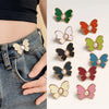 A collection of various colored pearl butterfly buttons for fastening jeans.