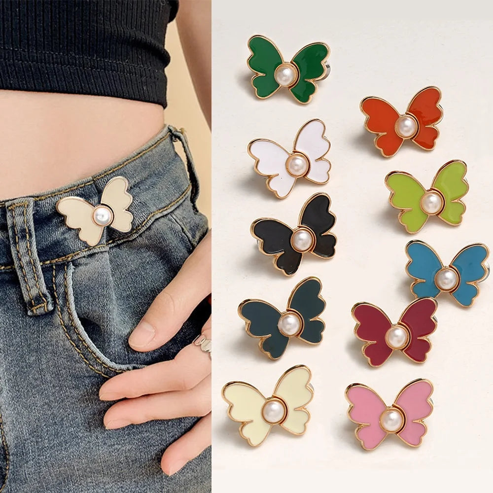 A collection of various colored pearl butterfly buttons for fastening jeans.