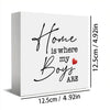 A white rectangular sign with black script text that reads Home is where my Boys are and a small red heart.