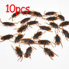 Ten plastic cockroach gag toys scattered on a white background.