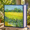 A blue photo album titled Cherished Moments featuring a bright yellow field of flowers and green foliage.