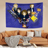 A tapestry featuring characters from K-ON! anime in blue and yellow tones displayed on a wall.