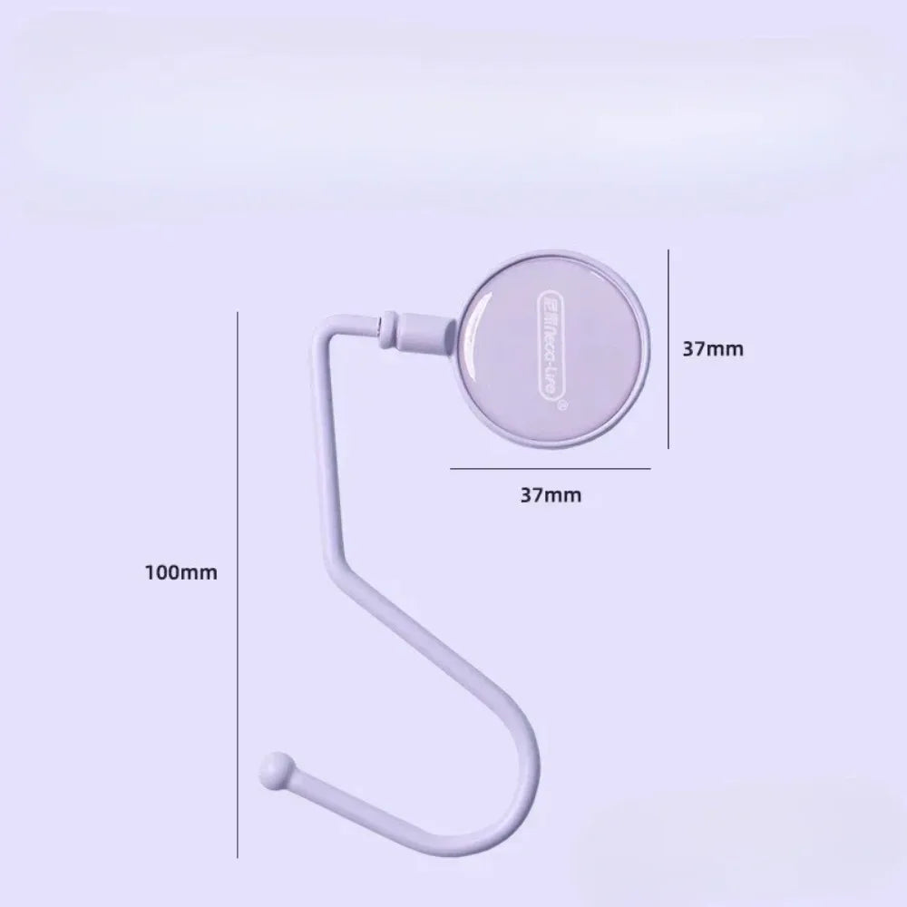 A purple heavy duty purse and bag hook with a circular attachment and a curved wire arm.