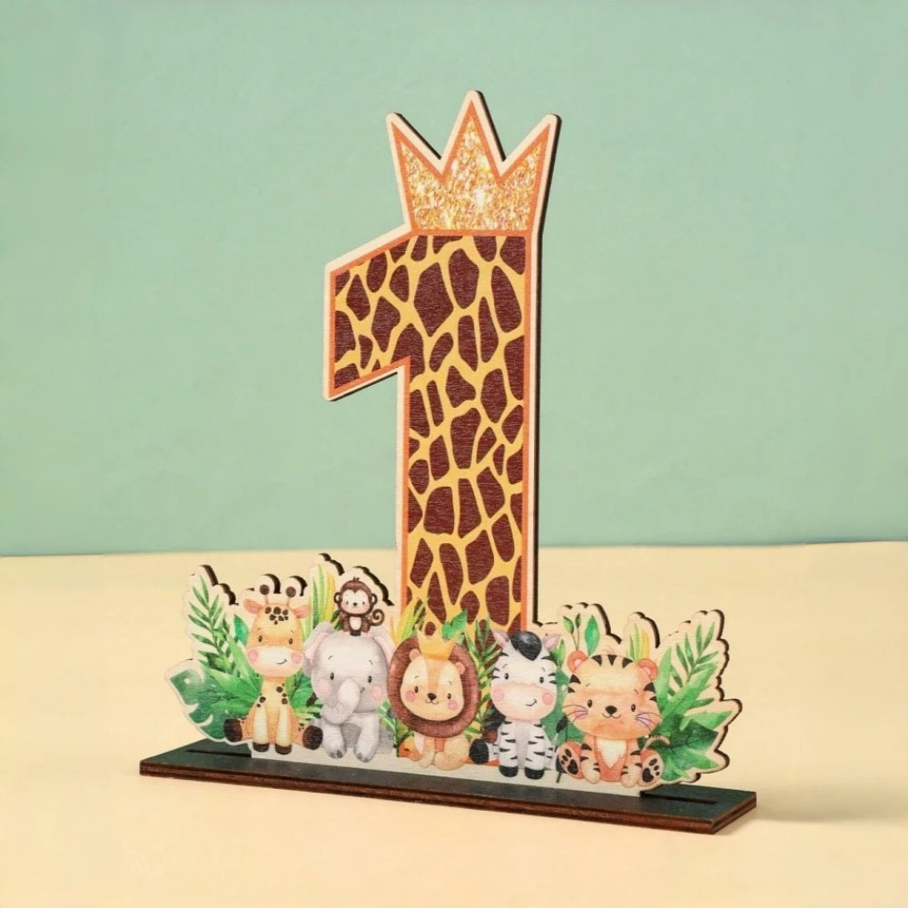 A wooden party ornament shaped like the number one featuring a leopard print and a crown, surrounded by small animal figures.