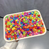A plastic tray filled with colorful flower and star hair claw clips for kids