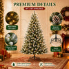 A flocked artificial Christmas tree decorated with warm white LED lights and a sturdy metal stand.