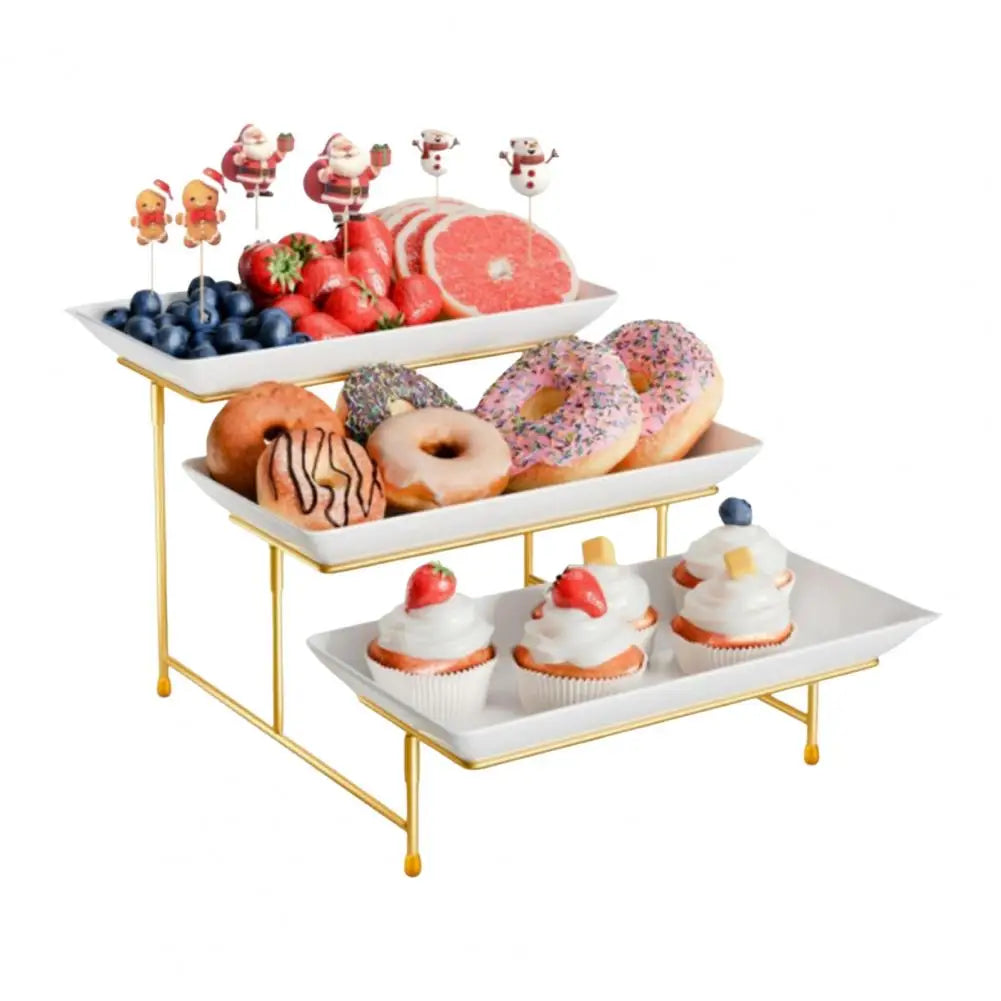 Elegant three-tier gold serving rack displaying various pastries and fruit