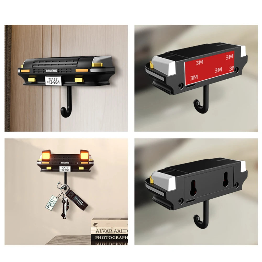A black classic car headlight key holder with LED illumination mounted on a wall.