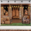 A rustic barn door backdrop featuring wooden doors, hay bales, and horses under string lights.