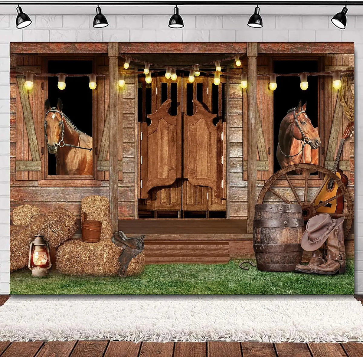 A rustic barn door backdrop featuring wooden doors, hay bales, and horses under string lights.