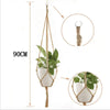 Handmade macrame plant hanger with a woven rope and a white pot for hanging plants