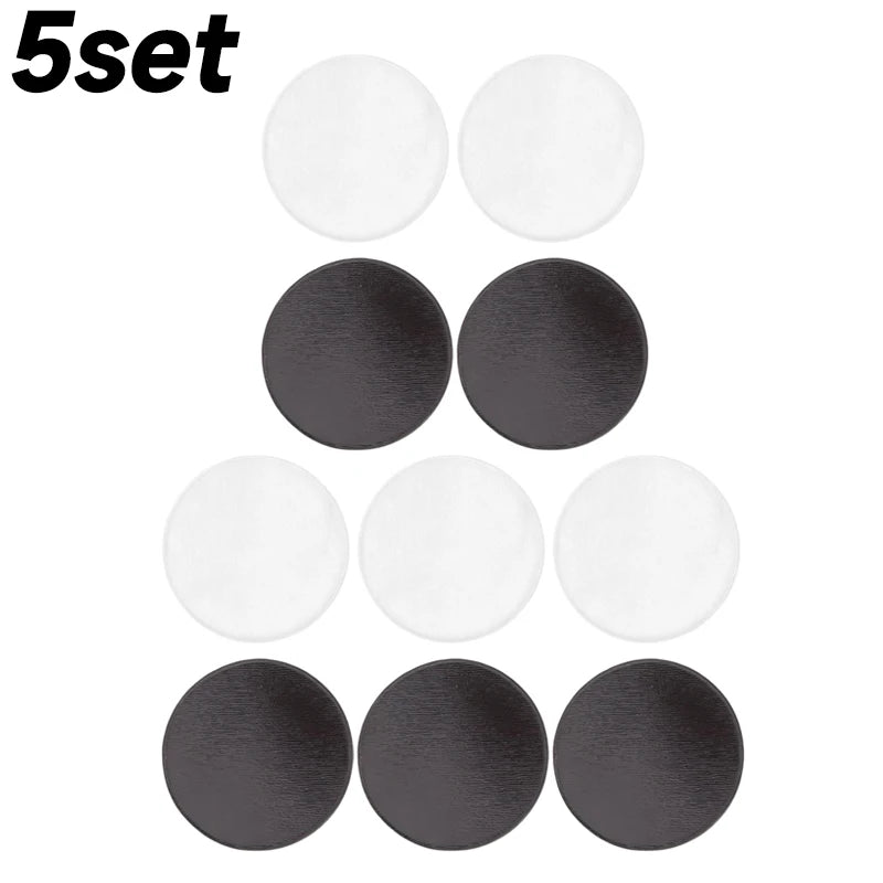 A set of five round clear acrylic fridge magnets in black and white finishes.