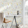 Boho floral peel and stick wallpaper featuring a dense pattern of multicolored wildflowers on a white background.