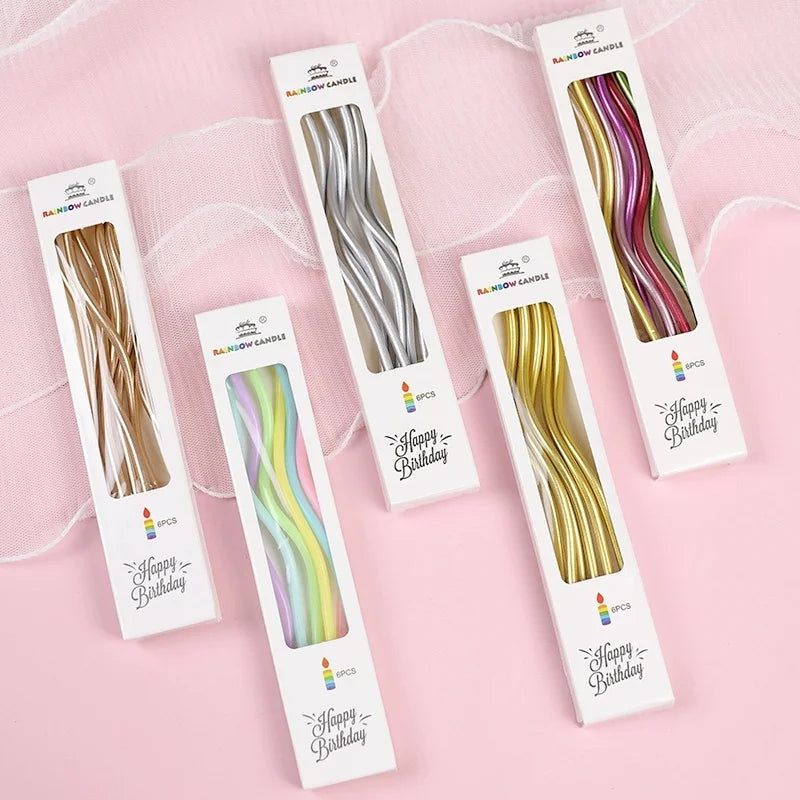 Pack of six curved metallic birthday candles in various shades of gold and green on white cards.