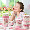 A collection of 12 rolls of retro floral washi tape in various pink and green patterns laid out on a white surface.
